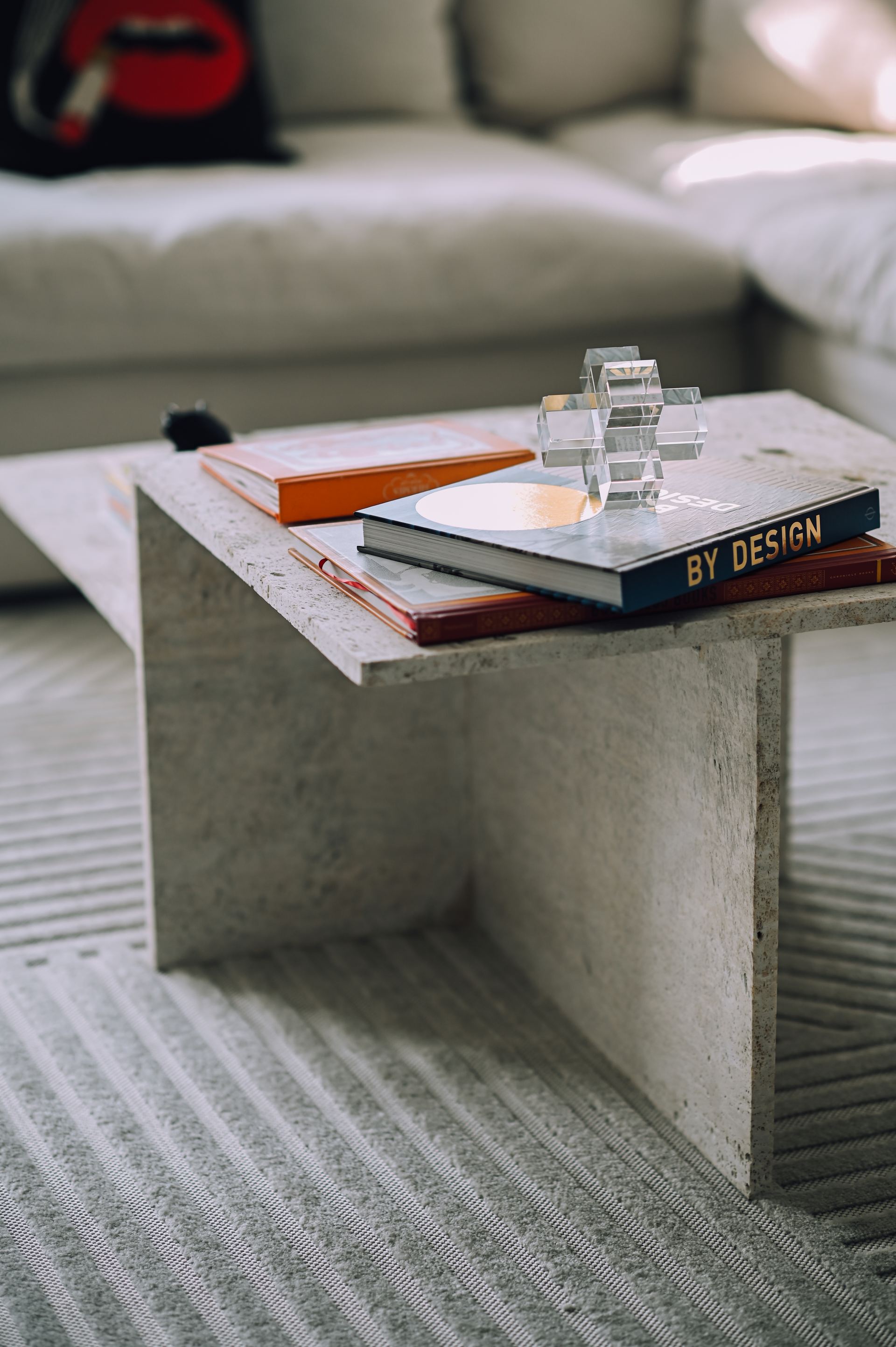 Concrete cantilevered coffee table styled with hardcover design books