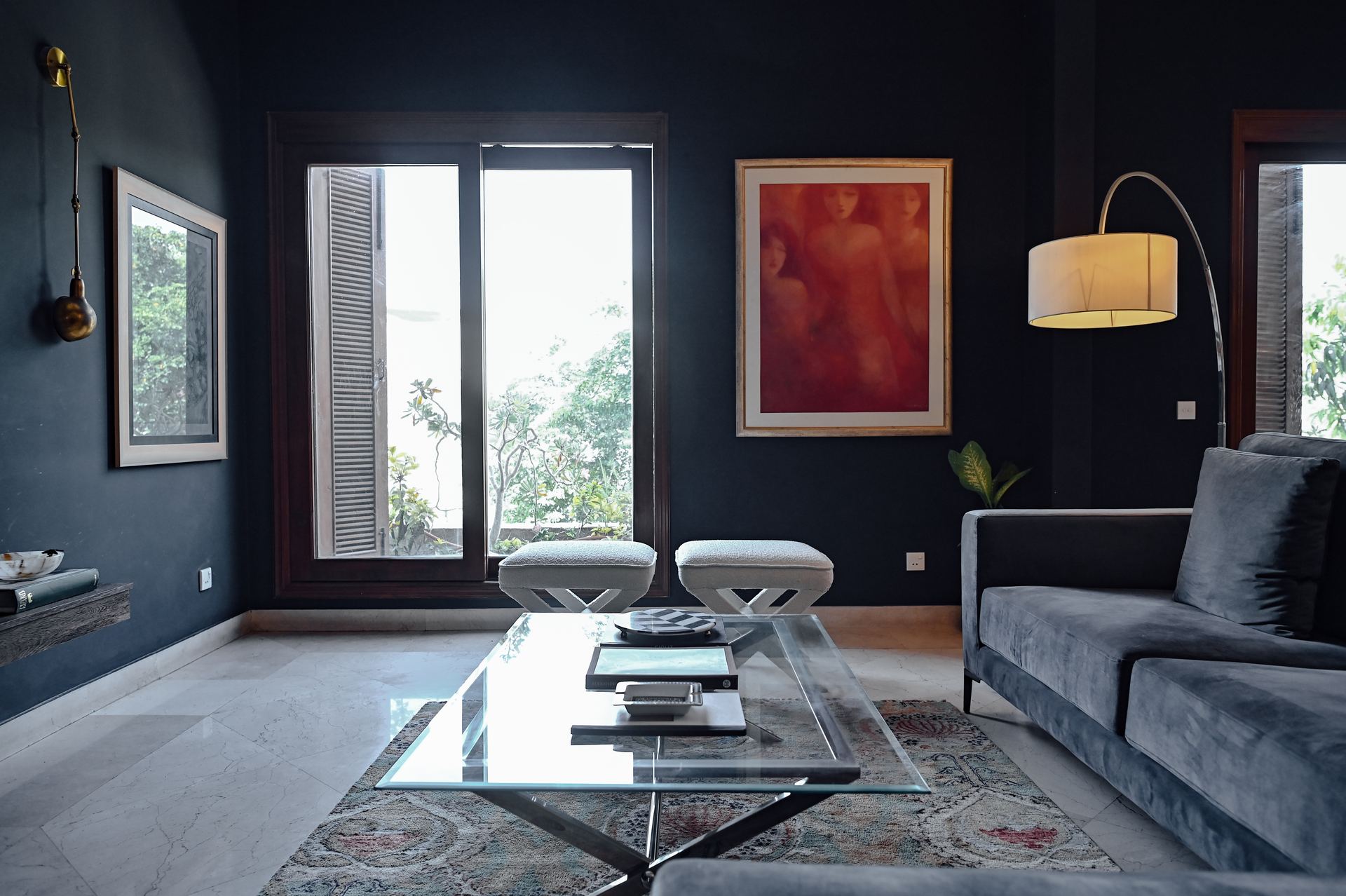 Charcoal living room with a red-toned portrait painting and an arc floor lamp
